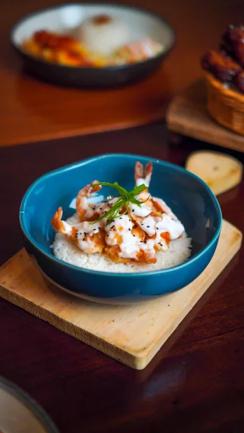 Blue bowl of rice topped with herbs