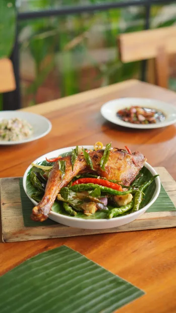 Prawn salad plated on a banana leaf runner