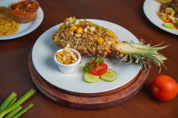 Fried rice served in a hollowed pineapple