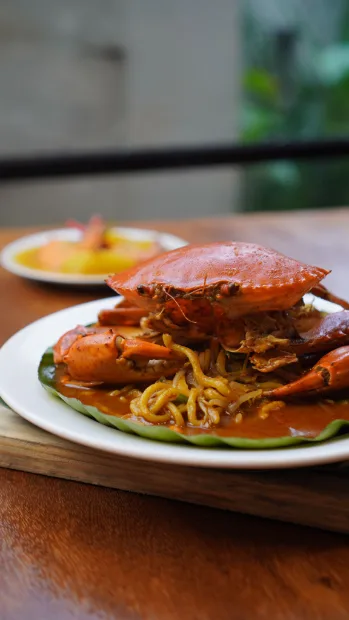 Crab dish plated on a dark table