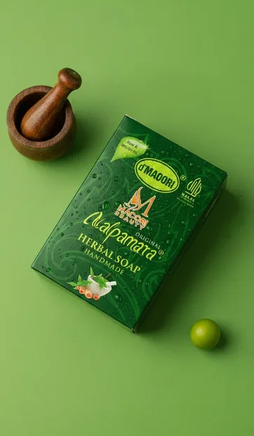 Herbal soap carton with a wooden pestle on green