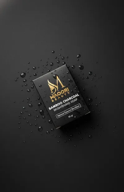 Charcoal soap bar on a wet black surface